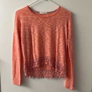 Long sleeve pink cropped front top with crochet detail at the bottom